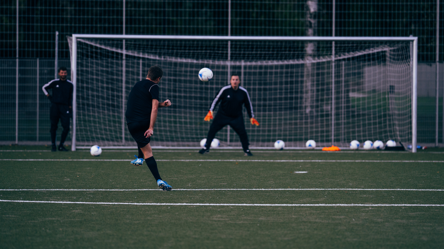 Team playing football on sports field